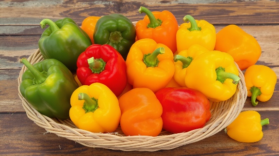 Basket of colorful bell pepper varieties.